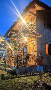 a woman standing in front of a house at Almare Guest House Siquijor in San Juan