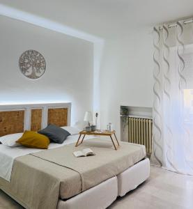 a bedroom with a large bed with a table on it at B&B Stella Dei Venti in San Salvo