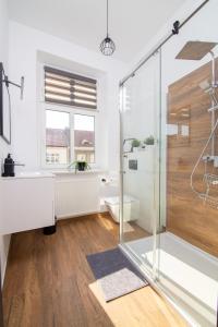 a bathroom with a shower and a toilet and a sink at Portowa 11 Gdynia in Gdynia