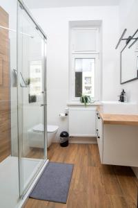 a bathroom with a shower and a sink and a toilet at Portowa 11 Gdynia in Gdynia