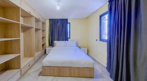 a small bedroom with a bed and a window at KHALIJ HOSPITALITE in Dakhla