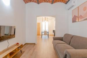 a living room with a couch and a table at Royal Apartment by Toh Solution in Turin