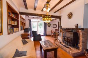 a living room with a couch and a fireplace at Casona con gran jardín in Camargo