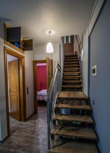 a staircase in a house with a hallway and a room at cozy house in Vlikhon