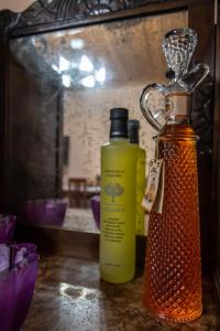 two bottles of liquid sitting on top of a table at cozy house in Vlikhón