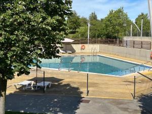 una piscina con una valla alrededor en Apartamento Cosy. Bonito y Acogedor Duplex, en Latas