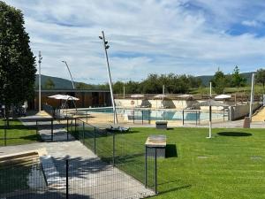 a swimming pool with a fence around it at Apartamento Cosy. Bonito y Acogedor Duplex in Latas
