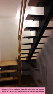 a staircase in a house with wooden risers at La Casetta Ferrara B&B in Ferrara