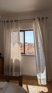 Ένα ή περισσότερα κρεβάτια σε δωμάτιο στο Ericeira Holidays