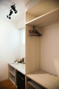 a room with a closet with a desk and a cupboard at Al Pozz Boutique Resort in Locarno