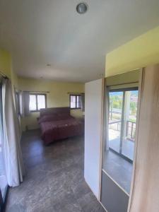 a living room with a couch and a window at Thai style 3 bedroom pool house. in Khao Lak +7 photos