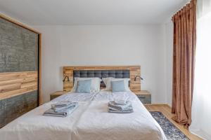 a bedroom with a large bed with towels on it at Holiday House Lena in Baderna