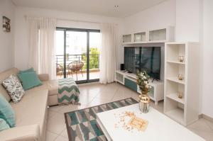 un soggiorno con divano e TV di Almond Apartment by OCvillas ad Albufeira
