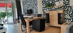 a room with a wooden table and black and white wallpaper at Fewo RELAX in Borken