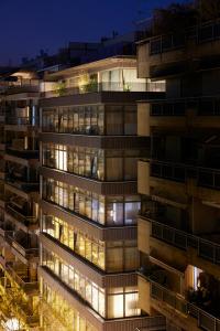 a tall building with many windows at night at Teight Hotel in Thessaloniki