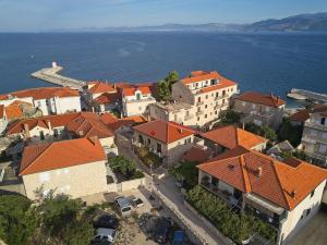 an aerial view of a town with orange roofs at Spacious apartment 50 m from the beach in Postira