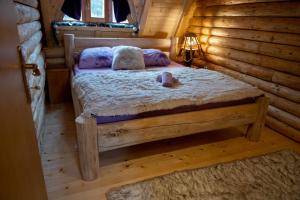 a bedroom with a bed in a log cabin at Ivana in Kupres