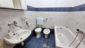 a bathroom with a sink and a tub and a toilet at Apartment Gogo Duce in Duće +32 photos