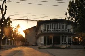a house with the sun setting in front of it at Khaoyai Terrazzo in Mu Si