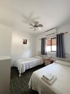 a bedroom with two beds and a ceiling fan at CASA VICENTE FUENTE in Sant Ferran de Ses Roques