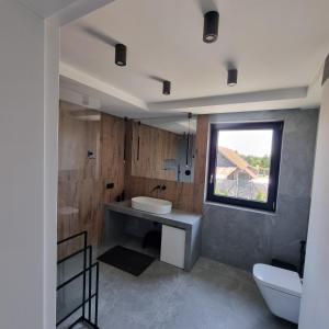 a bathroom with a sink and a window at Premium House Osztynek in Olsztynek +29 photos