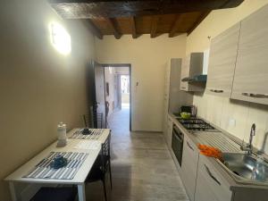 a kitchen with a sink and a counter top at Le casette sugli archi in Sutri