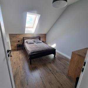 a bedroom with a bed and a skylight at Premium House Osztynek in Olsztynek