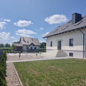 a white house with a black roof at Premium House Osztynek in Olsztynek