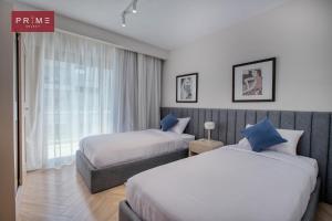 a hotel room with two beds and a window at Prime Select Galleria New Cairo in New cairo