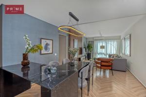 a kitchen and living room with a large black counter top at Prime Select Galleria New Cairo in New cairo