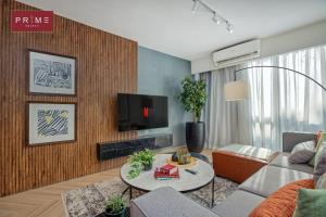 a living room with a couch and a tv at Prime Select Galleria New Cairo in New cairo