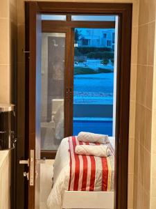 a room with a door with a window and a bed at Hawana Lagoon Private villa with private pool in Salalah