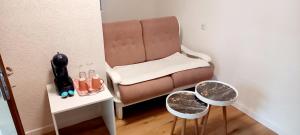 a small room with a brown chair and a mirror at Carmen apartman in Brčko