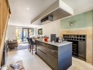 a kitchen with an island with a counter top at Squirrel Cottage in Glossop