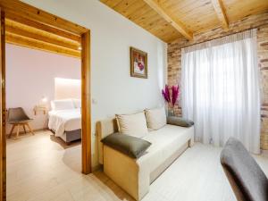 a living room with a couch and a bed at Nymfes Corfu Apartments in Corfu Town