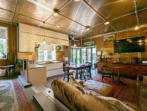a living room with a couch and a kitchen at Moorhen Lodge in Wickham
