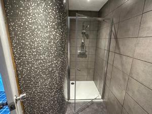 a bathroom with a shower with a glass door at The Valentine - Townhouse Hotel in Edinburgh