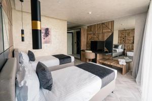 a hotel room with two beds and a television at хотел ADDRESS in Ravda +129 photos