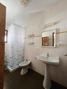 a bathroom with a sink and a toilet and a mirror at CASA VICENTE FUENTE in San Ferrán de ses Roques