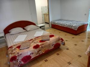 ein Schlafzimmer mit 2 Betten mit Blumen darauf in der Unterkunft Bugenvilija in Budva