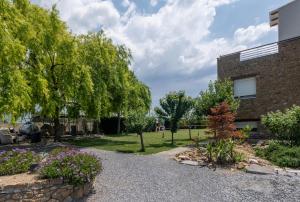 a garden with trees and flowers next to a building at Kellys house in Epanomi