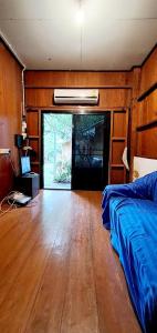 a bedroom with a bed and a wooden floor at Pai Yard Guest House in Pai