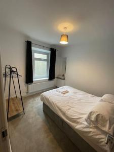 a bedroom with a bed and a window at The Mount in Swansea