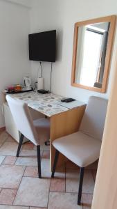uma secretária com um computador e uma cadeira num quarto em Guesthouse ROCK & ROLL em Rovinj