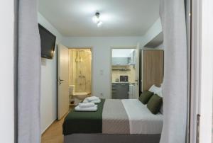a hotel room with a bed and a bathroom at C Apartments in Melissátika