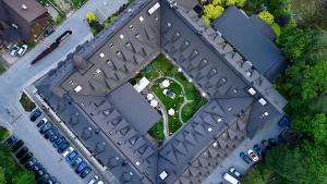 an overhead view of a building with parked cars at Aries Hotel & SPA Zakopane in Zakopane