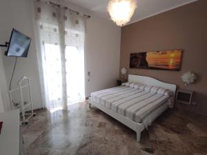 a bedroom with a bed and a television in it at Miramare Apartments in Otranto
