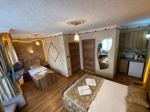 a room with a bed and a living room at GOLDEN ARROW OLD CİTY HOTEL in Istanbul