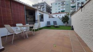 a patio with a table and chairs on a building at Casa junto al mar in Blanes