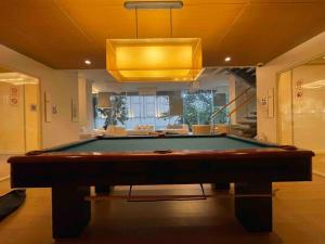 a pool table in a living room with a light at Luxurious in Prime Area Bangkok (PickupService) in Bangkok